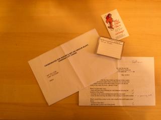 Package content (DV tape, business card, GPS coordinates)