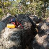 An axe and a multimeter on a rock