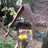 Lo-fi spirit house near a parking at the dam